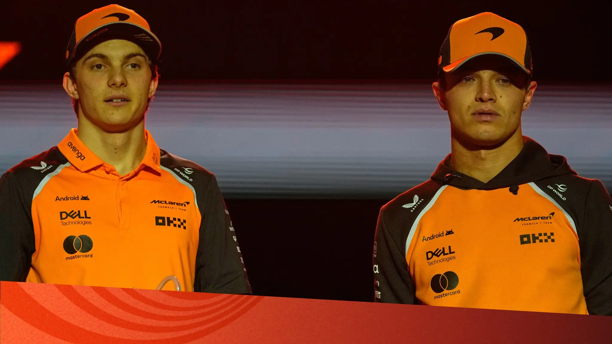 Två killar i orange keps och t-shirt.