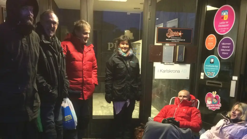 Personer med varma kläder köar framför turistbyrån i Karlskrona.