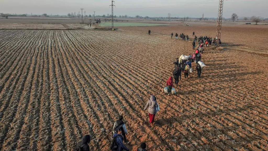 Migrants walk towards Greece along the Turkey-Greece border near Pazarkule