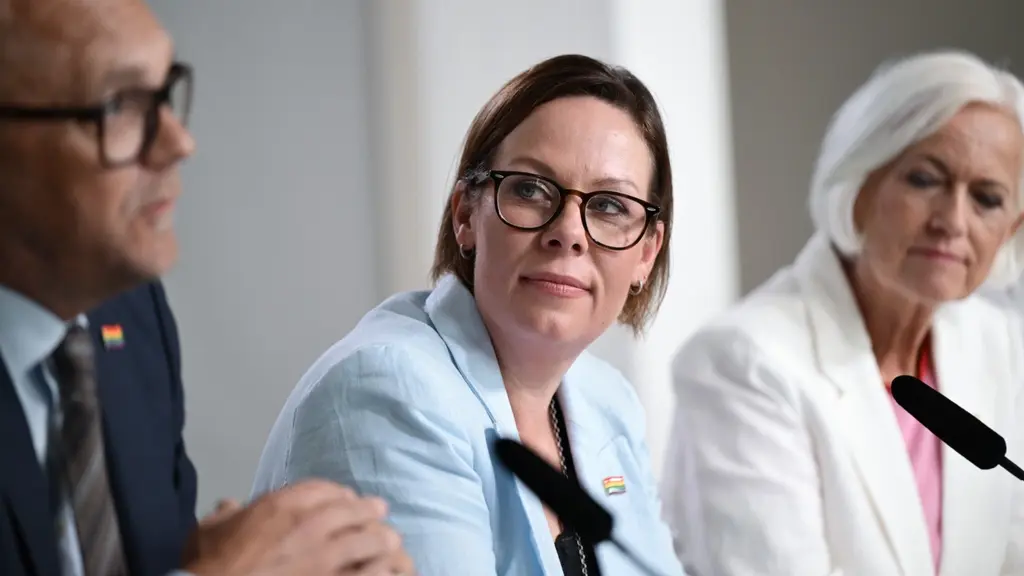 Foreign minister maria malmer stenergard sitting at a table with other representatives of the government.