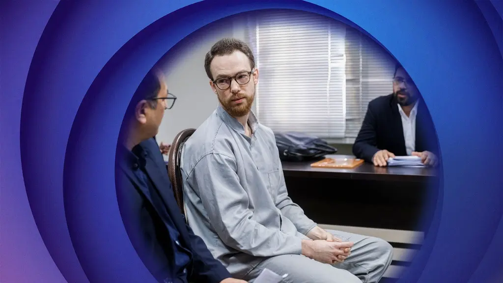 A man in a grey suit in a courtroom