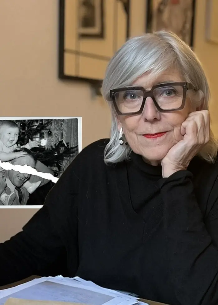 Elisabeth vid skrivbordet med bilden av sig själv som barn bakom