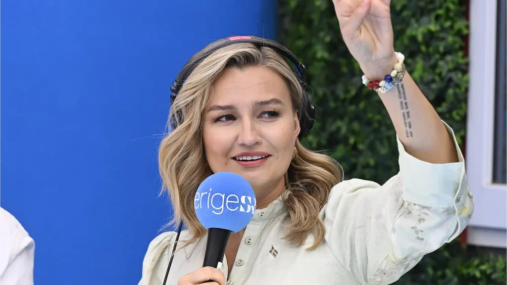 KD-ledaren Ebba Busch intervjuas i Sveriges Radios studio under Almedalsveckan i Visby. Busch vinkar mot publiken.