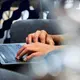Image 10: Närbild på händer som skriver på tangentbord på laptop.