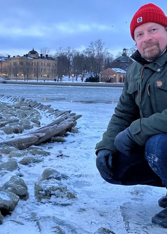 Vrakexperten Jim Hansson på brevid skelletet av ett skeppsvrak som sticker upp ur isen vid Kastellholmen i Stockholm 